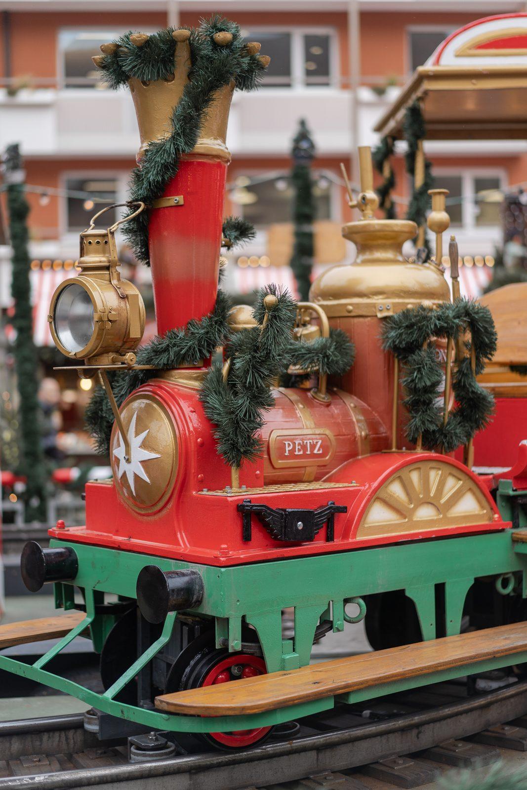 A little green and red train at a German Christmas market